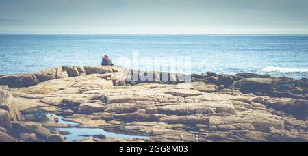Acadia National Park, ME, October 5, 2020: Elderly couple enjoying a beautiful day on the Atlantic coast of Acadia National Park Stock Photo