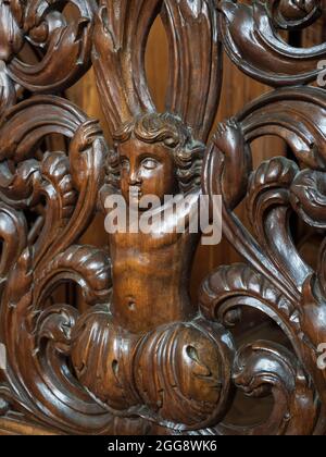 Carved wooden door of the sacristy, church, Ennezat, Puy-de-Dôme, Auvergne-Rhône-Alpes, France. Stock Photo