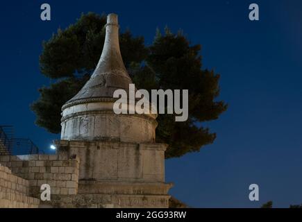 View at night of the tomb of Absalom, also called Absalom's Pillar, which is an ancient monumental rock-cut tomb with a conical roof dating to the 1st century AD located in the Kidron Valley or Wadi an-Nar in Jerusalem, Israel Stock Photo