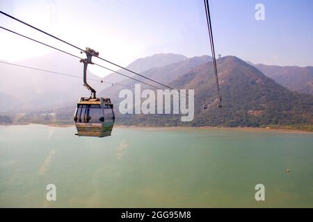 Ngong Ping Cable Car over Tung Chung Bay towards Lantau Island and Big Buddha Stock Photo