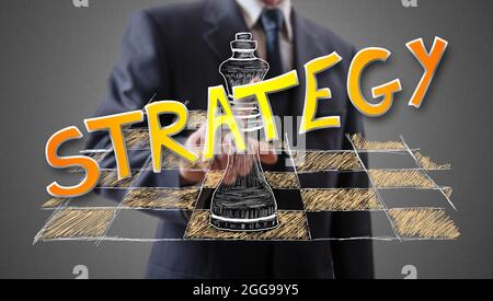 Strategy concept shown by a businessman in background Stock Photo