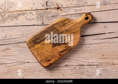 Wooden cutting board on wooden table Stock Photo