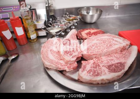Close up of marbled beef steaks on a plate at restaurant kitchen Stock Photo