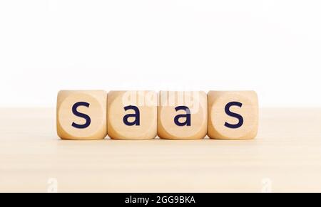 Saas word on wooden blocks on table. Copy space Stock Photo