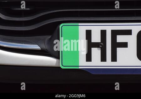 Close up photo of the green strip on the number plate of a British car that denotes the vehicle is zero emissions Stock Photo