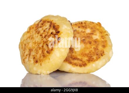 Two fragrant homemade cottage cheese pancakes, close-up, isolated on white. Stock Photo
