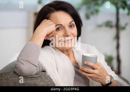 happy woman having a cup of tea Stock Photo