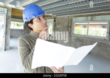 woman builder thinking of renovating space Stock Photo