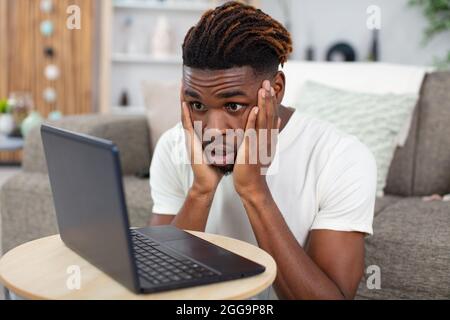 man having trouble with laptop at home Stock Photo