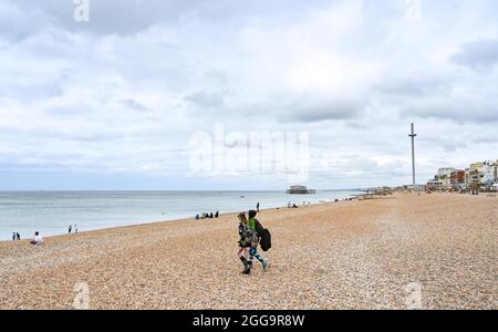 Brighton UK 30th August 2021 - Brighton beach is quiet on an overcast August bank holiday Monday morning .  : Credit Simon Dack / Alamy Live News Stock Photo