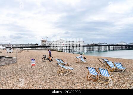 Brighton UK 30th August 2021 - Brighton beach is quiet on an overcast August bank holiday Monday morning .  : Credit Simon Dack / Alamy Live News Stock Photo