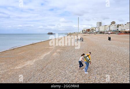 Brighton UK 30th August 2021 - Brighton beach is quiet on an overcast August bank holiday Monday morning .  : Credit Simon Dack / Alamy Live News Stock Photo