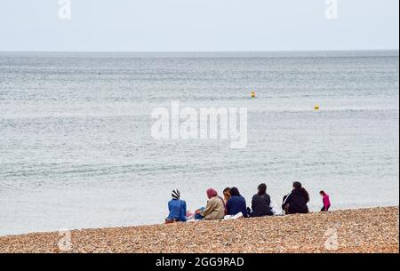 Brighton UK 30th August 2021 - Brighton beach is quiet on an overcast August bank holiday Monday morning .  : Credit Simon Dack / Alamy Live News Stock Photo