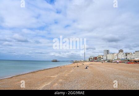 Brighton UK 30th August 2021 - Brighton beach is quiet on an overcast August bank holiday Monday morning .  : Credit Simon Dack / Alamy Live News Stock Photo