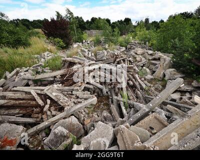 Oranienburg, Germany. 31st July, 2021. Dilapidated facilities of the former airport between Oranienburg and Leegebruch. The airfield was built in the 1930s and used by the Heinkel-Werke and the Luftwaffe of the Wehrmacht. After the end of World War II, Soviet occupation forces dismantled the facilities almost completely and used the remains of the factory airport as a military airfield. Around 2003, the newly built B 96 federal highway was built on a large section of the runway as Oranienburg's western bypass. Credit: Soeren Stache/dpa-Zentralbild/ZB/dpa/Alamy Live News Stock Photo