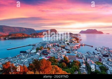 Colorful sunset in Alesund port town on western coast of Norway. Place where the ocean meet the mountains. Landscape photography Stock Photo