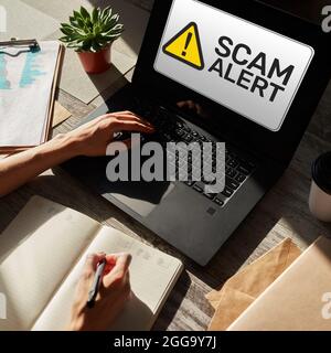 Scam alert detecting warning. Notification on device screen Stock Photo