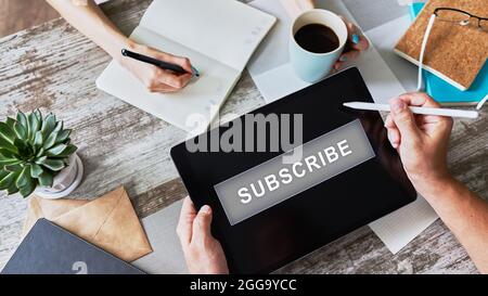 Subscribe button on device screen. Internet and digital marketing concept Stock Photo