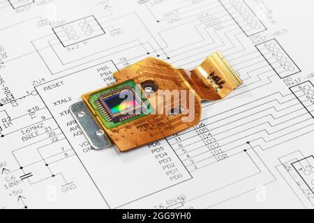 CMOS sensor on flexible printed circuit board against the background of a schematic electrical diagram Stock Photo