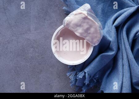 fresh yogurt in a plastic container on black background  Stock Photo