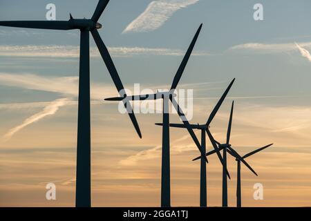 Wind turbine energy generators on wind farm Stock Photo