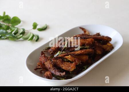 Crispy and spicy Anchovy fry. Anchovies marinated with spices and deep fried. Popular fish dish from Kerala called Natholi fry. Stock Photo
