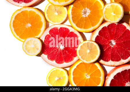 Bright multicolored citrus slices isolated on white background. Stock Photo