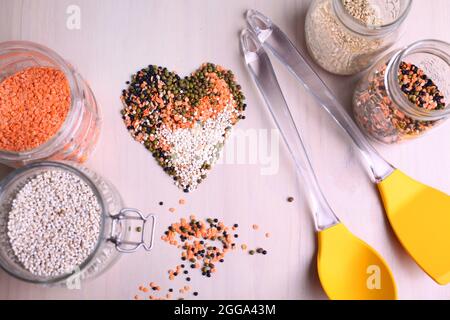Red white, and black lentils forming a valentine heart shape for healthy living Stock Photo