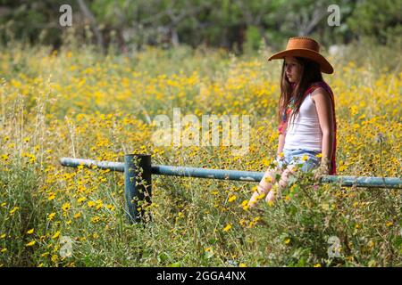 Pensive girl of 12 in a field Stock Photo