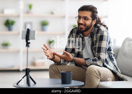 handsome arab guy with glasses blogger streaming from home Stock Photo