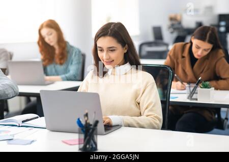 Portrait of female student using laptop in classroom Stock Photo