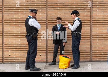 London, UK. 30th Aug, 2021. Police stop and search an activist at the News Corp building during the Extinction Rebellion protest as they hold 'The Impossible Tea Party' in London. (Photo by Dave Rushen/SOPA Images/Sipa USA) Credit: Sipa USA/Alamy Live News Stock Photo