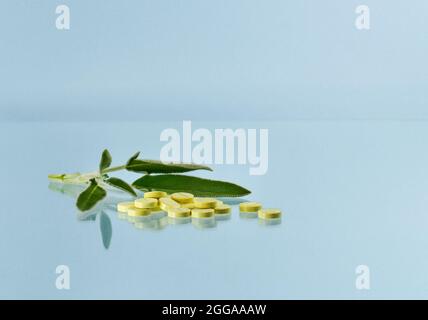 Tablets with sage extract on a blue background. Stock Photo