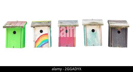 Row of five weathered hand painted wooden bird houses isolated on a white background Stock Photo
