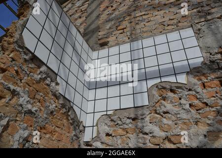Remodeling. Renovation of wall under construction with exposed trailer and white tile in bottom-up view, Brazil, South America Stock Photo