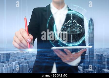 Woman In A Suit Virtually Writing On Screen Holding Tablet Showing Futuristic Technology. Businesswoman Wearing Uniform Handwriting Using Pad Stock Photo