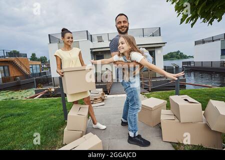 Cheerful mood of family moving into their new home Stock Photo