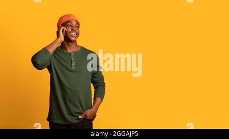 Mobile Call. Happy Young Black Man Talking On Cellphone Stock Photo