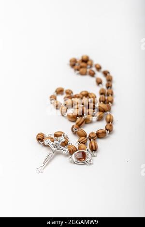 Christian souvenirs from the Holy Land Olive wood Rosary and crucifix on white background Stock Photo