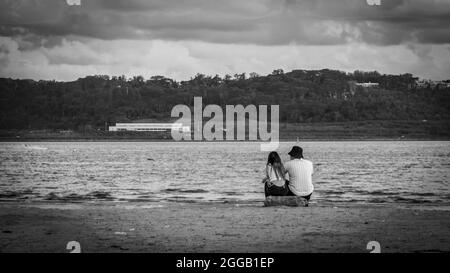 SUBIC, PHILIPPINES - Aug 01, 2017: A gray scale view of a Filipino couple dating at the beach of SMBA in Olongapo City Zambales Stock Photo