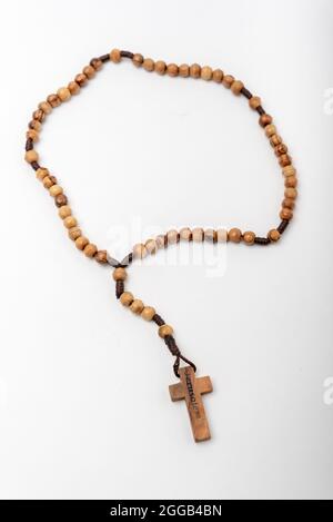 Christian souvenirs from the Holy Land Olive wood Rosary and crucifix on white background Stock Photo