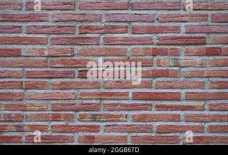 detail of a wall made of red and brown bricks Stock Photo