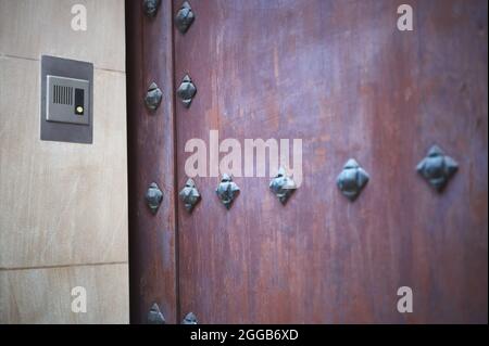 detail of a door entry system in an old house with a nailed door Stock Photo