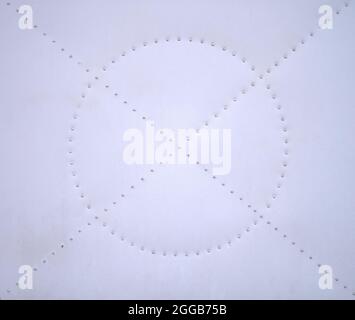 detail of a piece of white metal sheet or plate with rivets Stock Photo