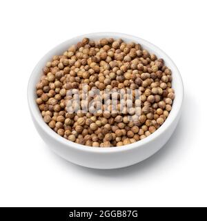Bowl with dried coriander seed isolated on white background Stock Photo