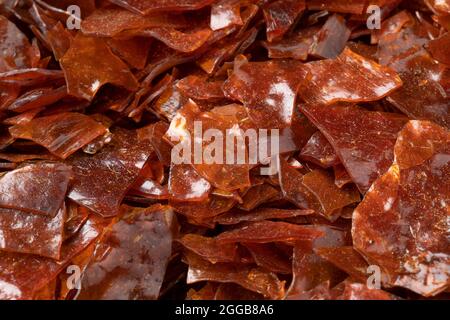 Brown Shellac dry flakes close up full frame as background Stock Photo