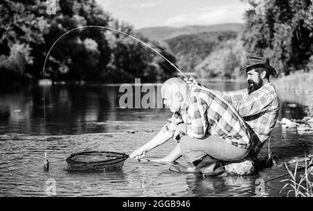 fly fish hobby of men. retirement fishery. Two male friends fishing together. big game fishing. relax on nature. happy fishermen friendship. retired Stock Photo