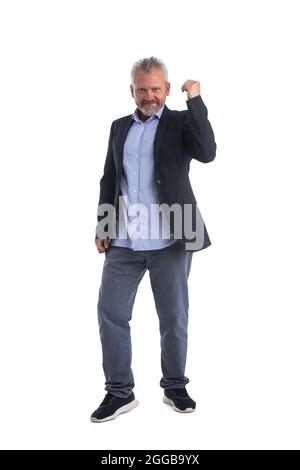 Senior businessman cheering his success raising fist in the air as he smiles with satisfaction isolated on white background Stock Photo