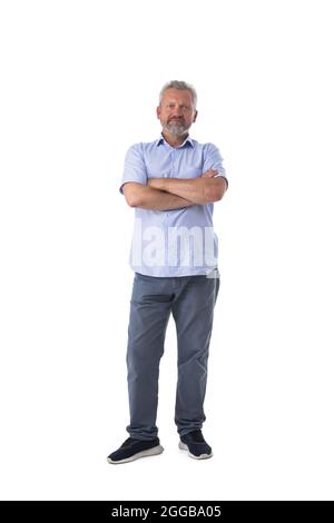 Middle aged man wearing shirt and jeans standing with Arms Folded isolated on white background Stock Photo