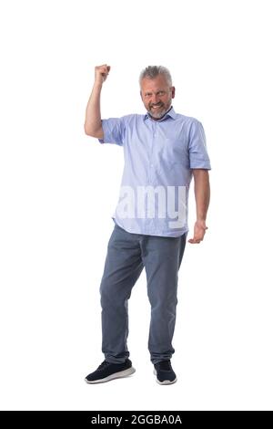 Senior man cheering his success raising fist in the air as he smiles with satisfaction isolated on white background Stock Photo